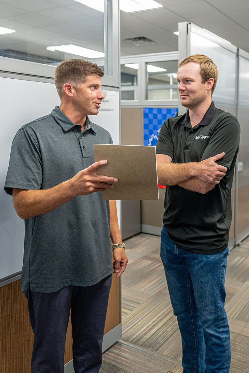 Jimmy Thomas, commercial project manager and estimation team leader, discusses a project with Adam Outlaw, McElroy’s project engineer.
