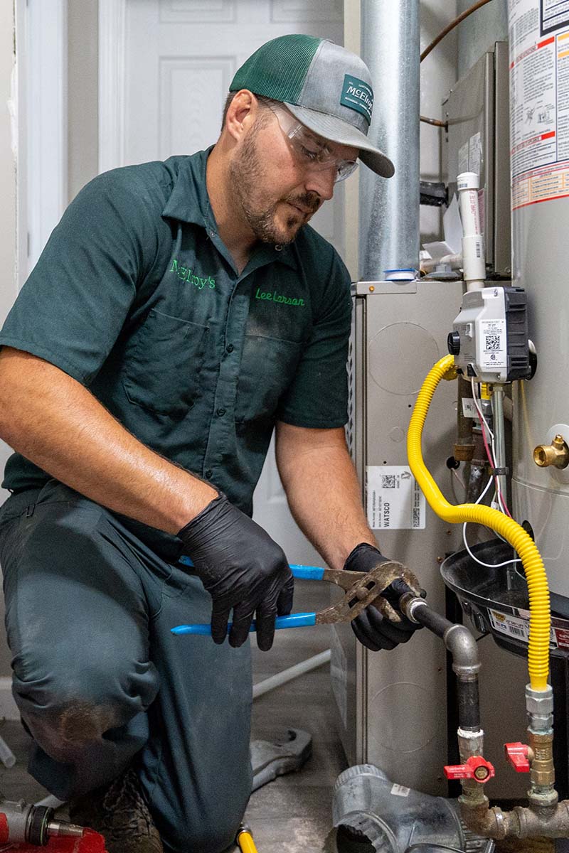Lee Larson, McElroy’s plumber, completes the connections of a new residential water heater.
