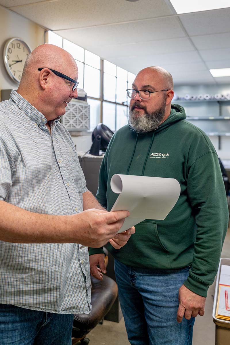 Martin Decker, McElroy’s sheet-metal team manager, discusses a project with fabrication shop foreman, Anthony Decker.