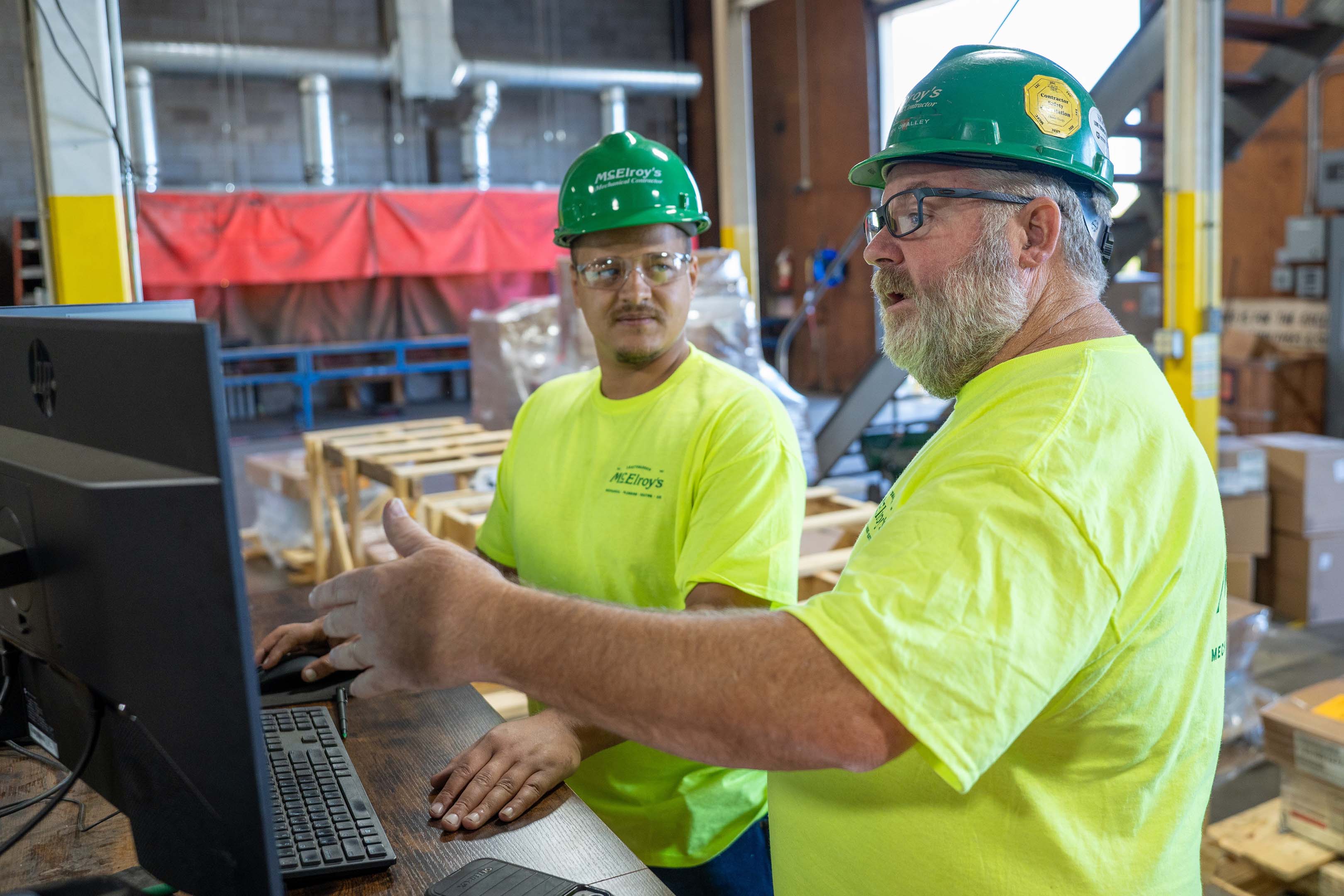 Shawn O’Malley, McElroy’s safety manager, discusses safety matters with a construction technician on the jobsite.