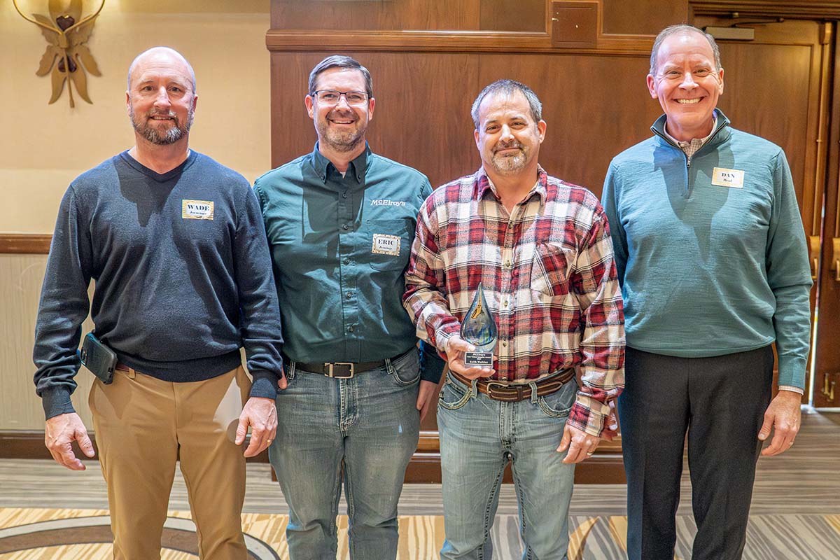 Wade Jueneman, Eric Jennings and Dan Beal present the 2025 McElroy's Core Values Integrity Award to Keith Watkins.