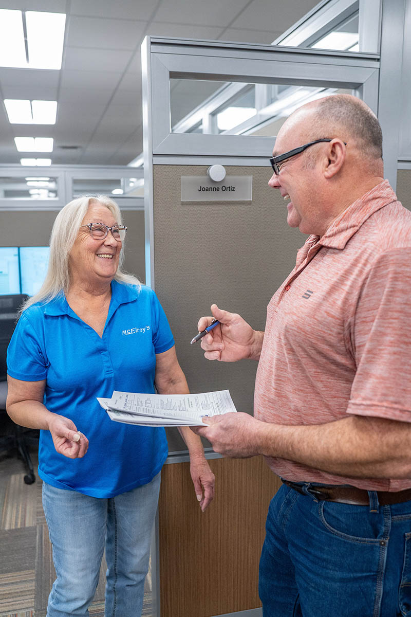 Joanne Ortiz, of the McElroy’s accounting team, works with Greg Hunsicker, leader of the McElroy's residential HVAC team.