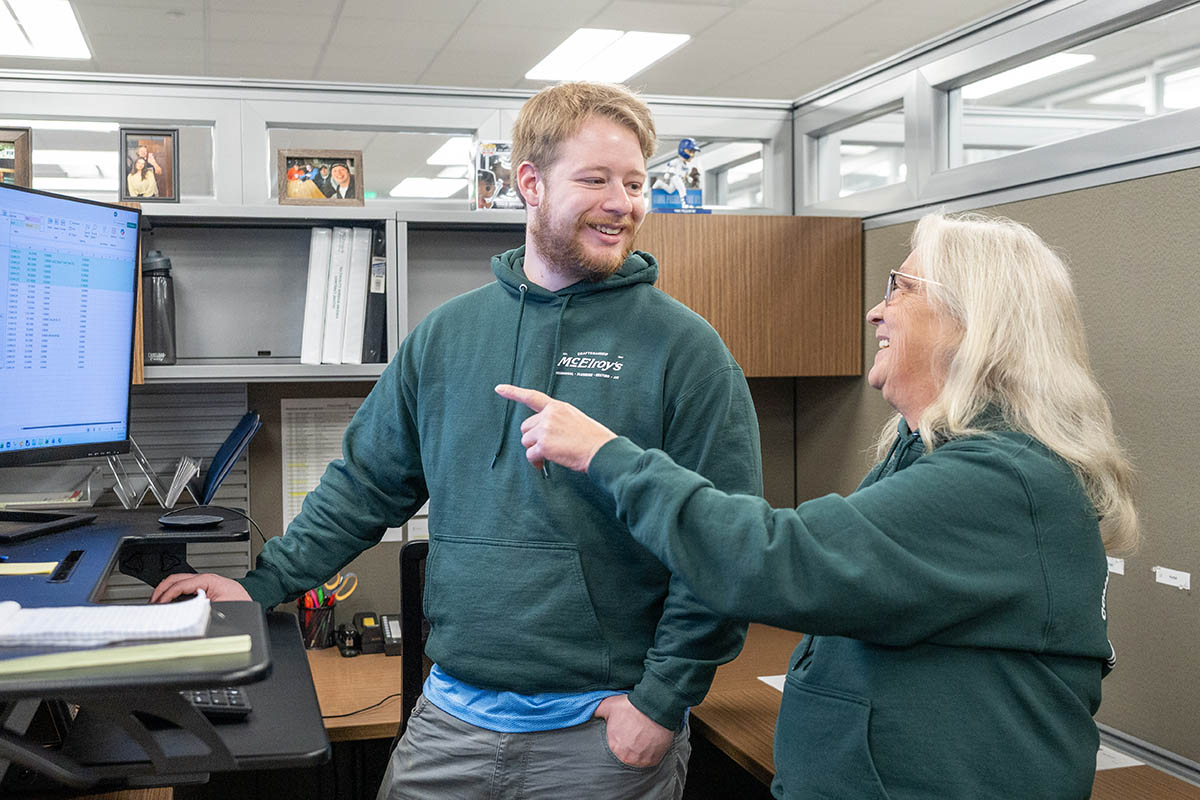 Joanne Ortiz, of the McElroy’s accounting team, mentors Aiden Eyman, McElroy’s accounts receivable specialist.