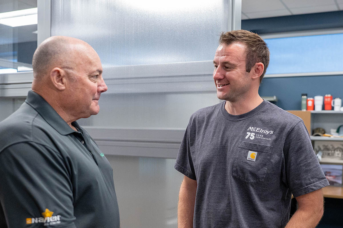 Brit Hunsicker, McElroy’s commercial HVAC service sales, talks with his father, McElroy’s residential HVAC leader, Greg Hunsicker.
