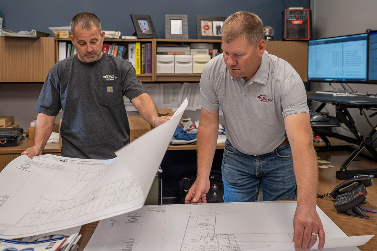 Jason Long, McElroy’s commercial HVAC service and McElroy Controls sales, reviews control system plans with Keith Watkins.