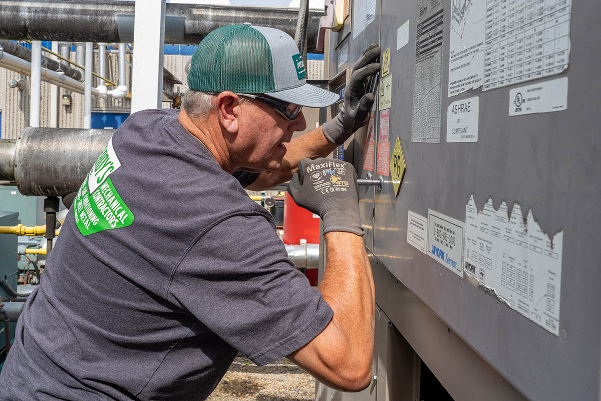 Chuck Buss, McElroy's commercial HVAC service technician, leans into complex HVAC system maintenance and repairs.