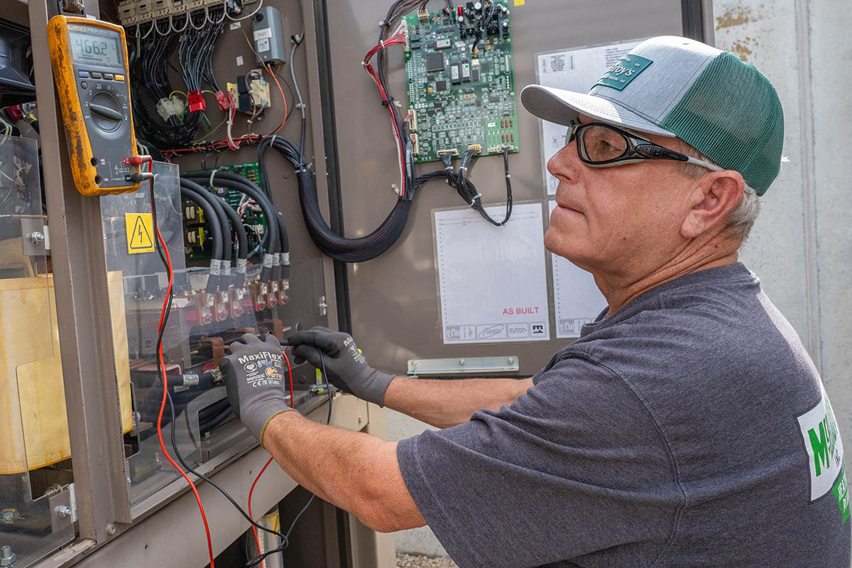 Chuck Buss, McElroy's commercial HVAC service technician, runs diagnostics on a complex HVAC system.