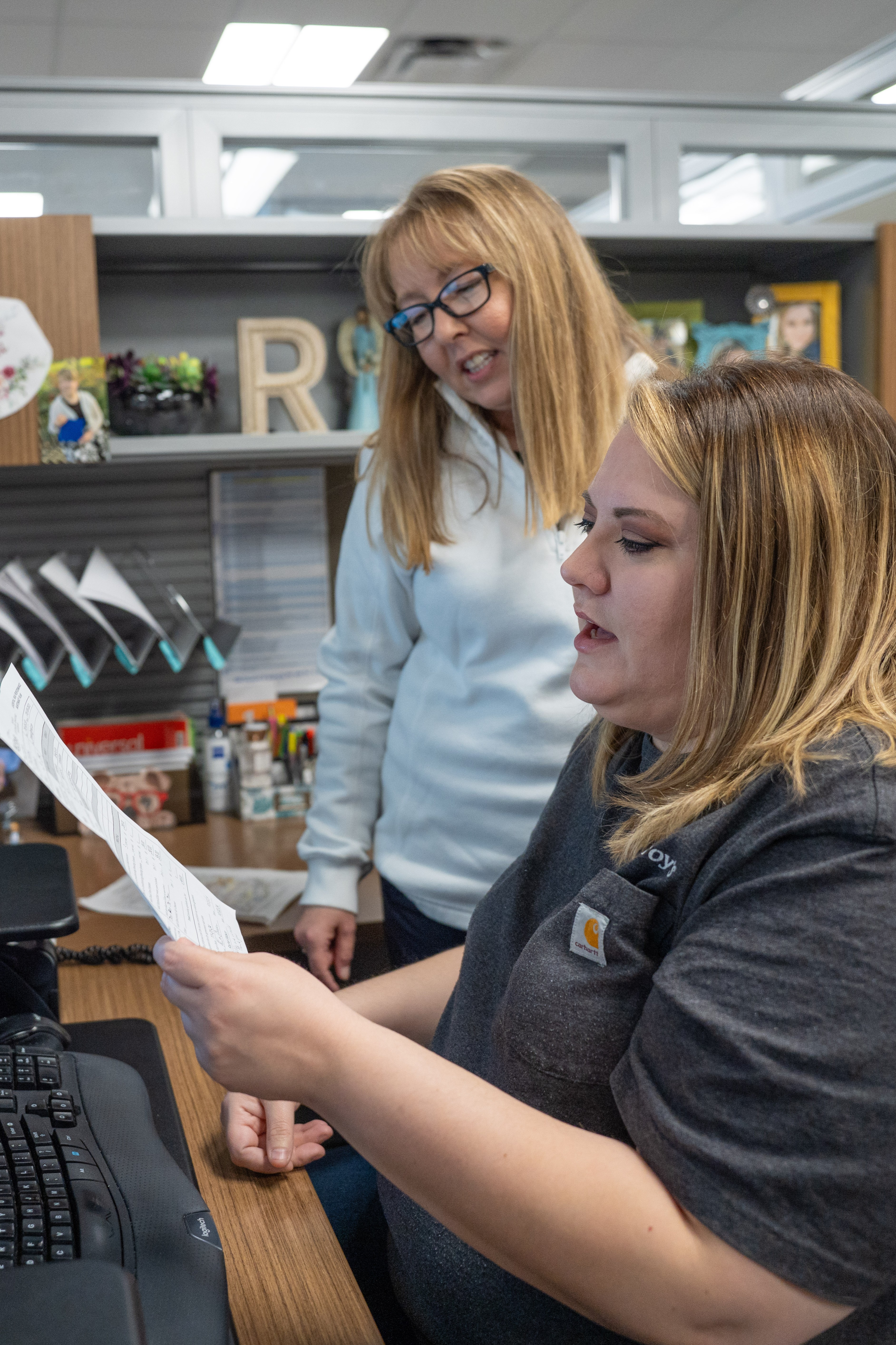 Cassie Benton, McElroy’s customer service manager, discusses residential service-contract customers with Rachel Watson.