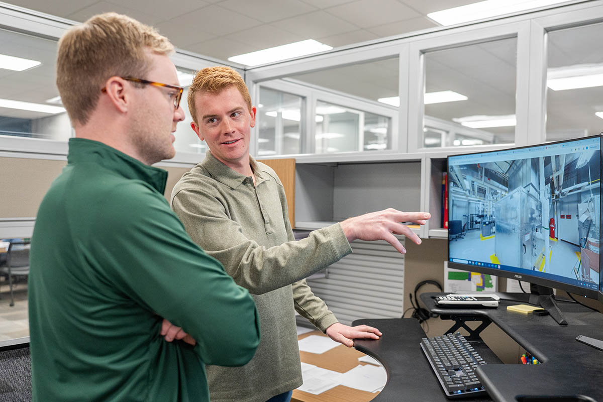 Parker Beal, McElroy’s project manager and licensed professional engineer, reviews digital project drawings with Adam Outlaw.